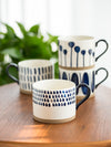 White Ceramic Coffee Cup with Blue Modern Designs